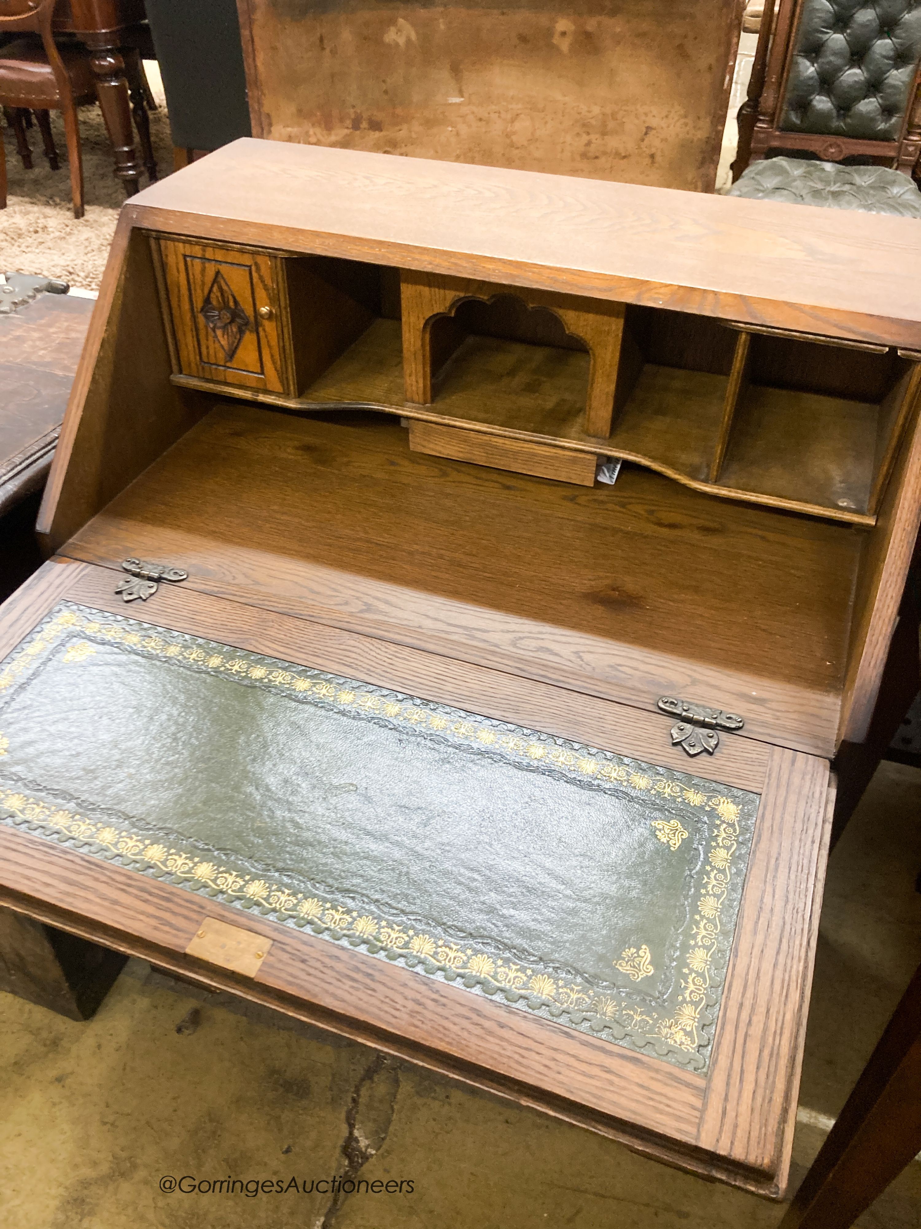 A reproduction oak linenfold carved bureau, W.75cm D.48cm H.99cm